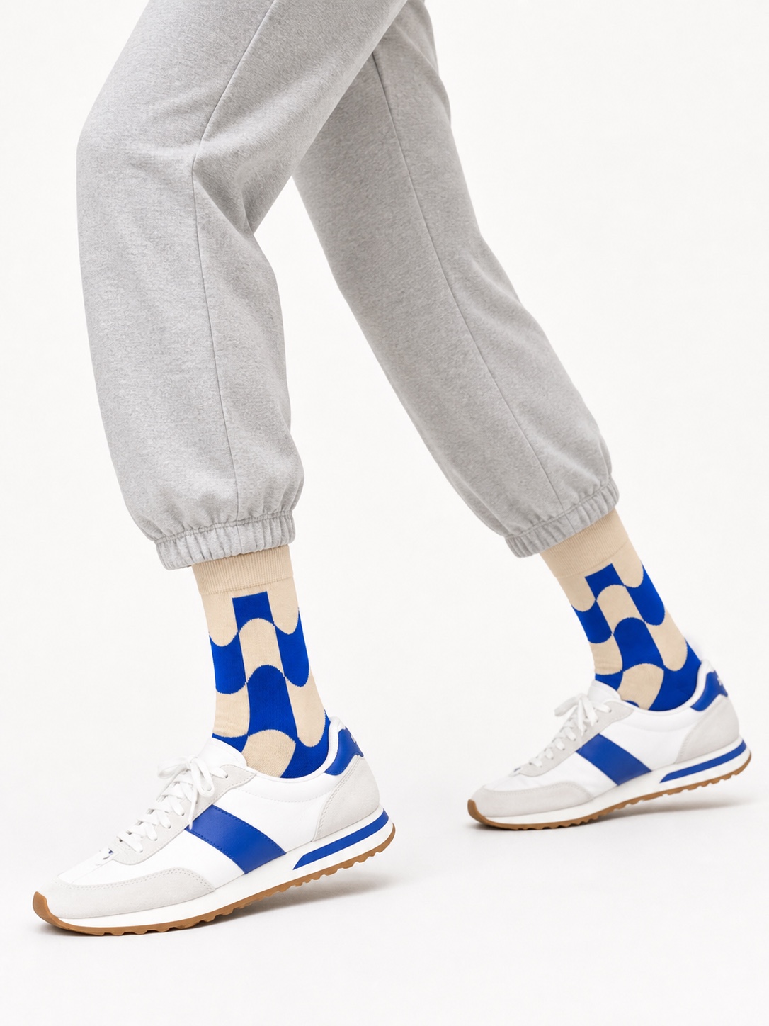 Cream Nollaknit socks with a bold cobalt wave pattern