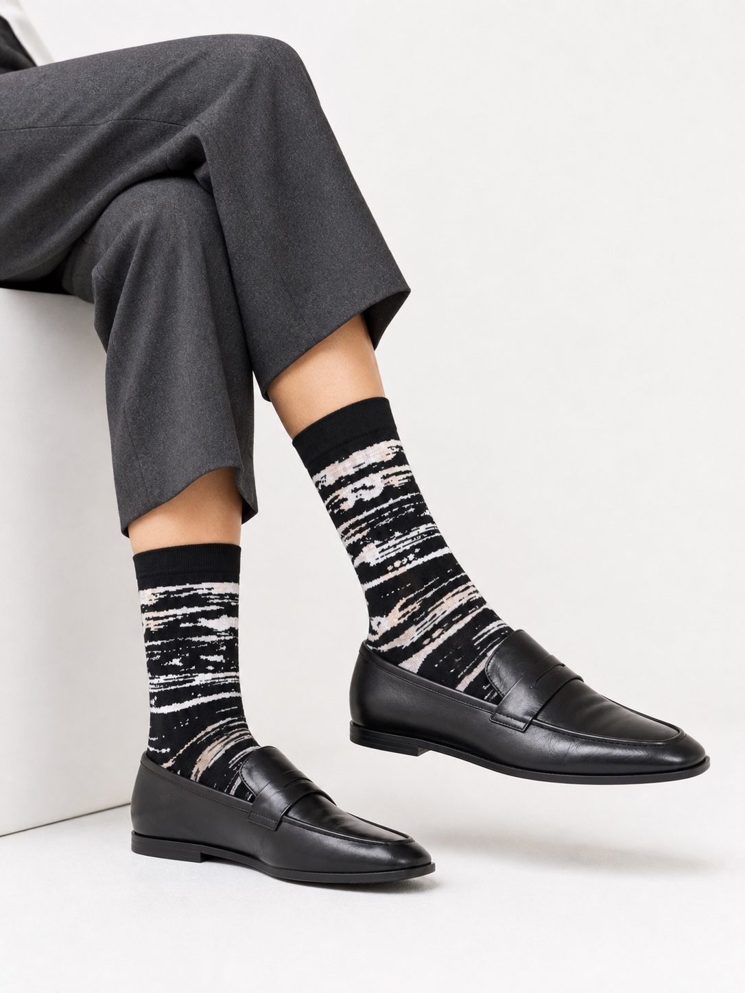 Black Nollaknit socks with an abstract cream Nordic pattern